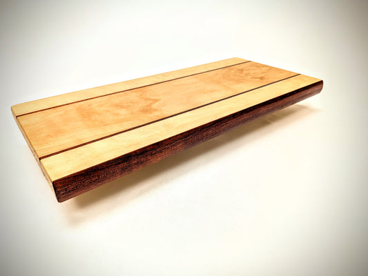 Artisan beech and bloodwood cutting board, featuring a unique design and vibrant, natural color contrast.